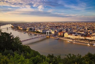 High angle view of bridge over river in city against sky