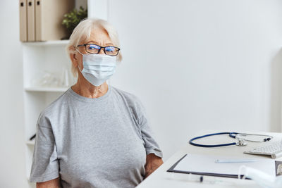 Portrait of man wearing eyeglasses on table