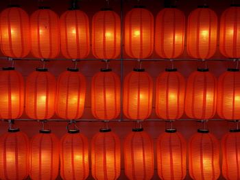 Illuminated lanterns hanging side by side