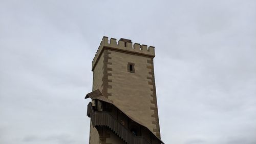 Low angle view of building against cloudy sky