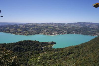 Scenic view of lake against clear blue sky