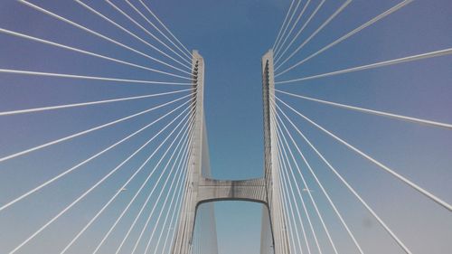 Low angle view of 25 de abril bridge against sky