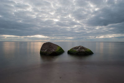 View of calm sea against cloudy sky