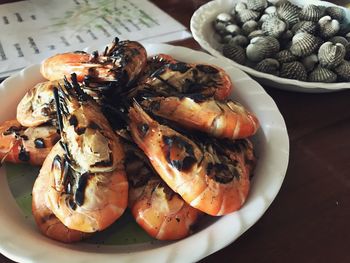 Close-up of roasted shrimps in plate on table