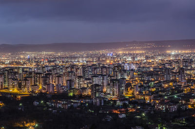 High angle view of illuminated city buildings at night