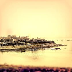 Boats in river at sunset