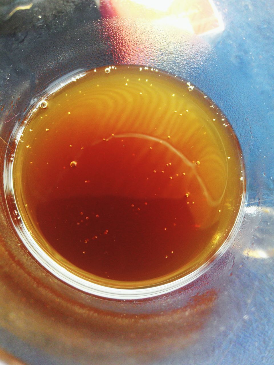 food and drink, drink, refreshment, freshness, indoors, close-up, still life, table, high angle view, red, drinking glass, healthy eating, glass - material, water, no people, orange color, directly above, liquid, frothy drink, reflection