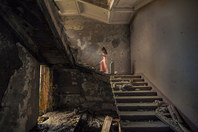 Woman standing on staircase