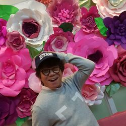 Portrait of boy with pink flowers