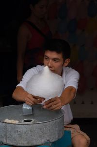 Portrait of a young man sitting on bench