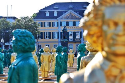 Statue by building against temple