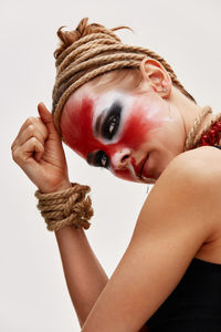 Portrait of young woman against white background