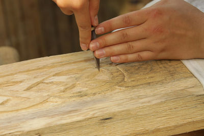 Cropped hand carving wood