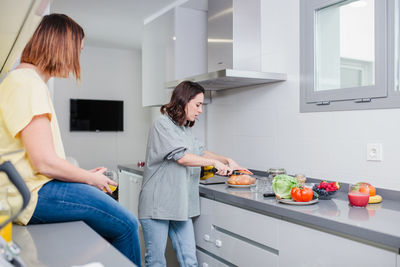 Women preparing food at kitchen