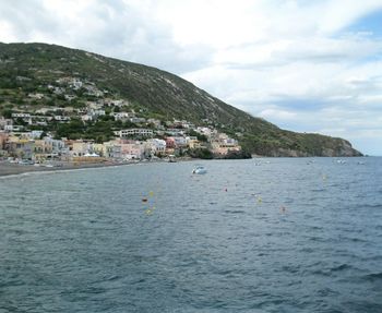 Scenic view of sea and mountains against sky