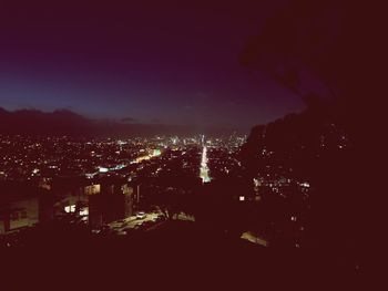 High angle view of illuminated buildings in city at night