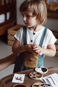 Close-up of boy playing with food at home