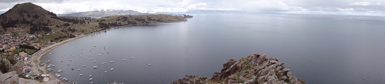 PANORAMIC VIEW OF SEA AND MOUNTAIN AGAINST SKY