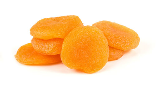 Close-up of orange fruit against white background