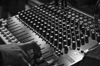 Cropped hand of man with sound recording equipment in studio