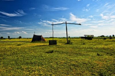 Scenic view of farm against sky