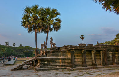 View of statues on palm trees