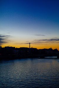 Scenic view of silhouette city against sky during sunset