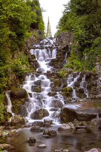 Stream flowing through rocks in forest