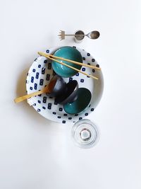 Directly above shot of tableware against white background