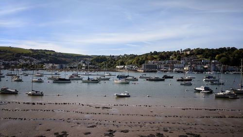 Boats moored in sea against sky