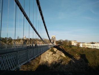 Suspension bridge against blue sky