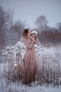 Woman in snow on field during winter