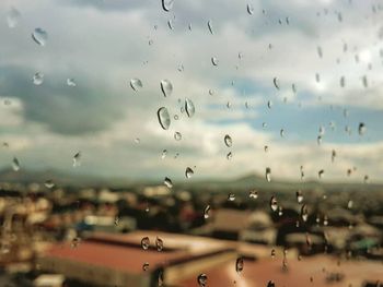 Close-up of wet glass window in rainy season