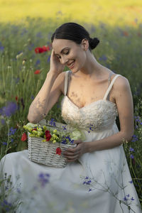 Portrait of young woman holding bouquet
