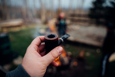 Man holding smoking pipe