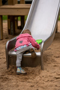 Little girl on a slide in the playground