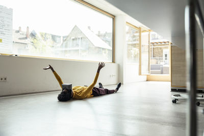 Man lying down on floor at home