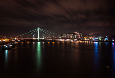 Suspension bridge over river at dusk