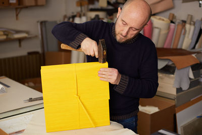 Man reading book at table