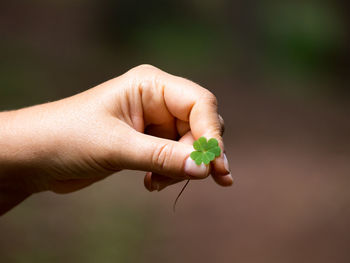 Close-up of hand holding small finger