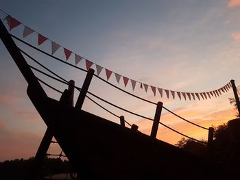 Low angle view of silhouette bridge against sky during sunset