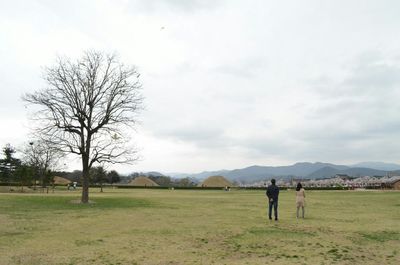 Scenic view of landscape against cloudy sky