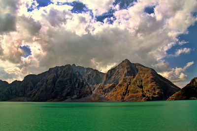 Scenic view of mountains against cloudy sky