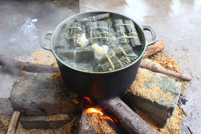 High angle view of food cooking in container on wood burning stove