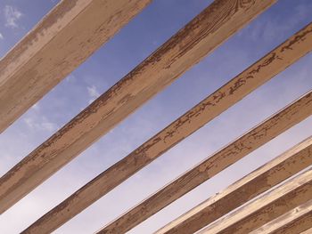 Low angle view of wooden structure against sky