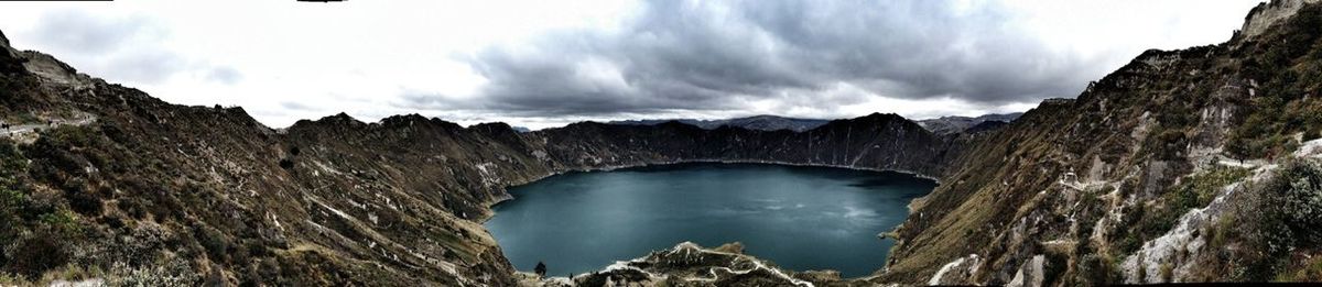 Scenic view of mountains against cloudy sky