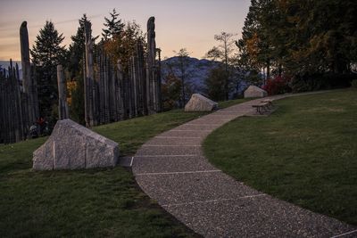 Footpath in park against sky