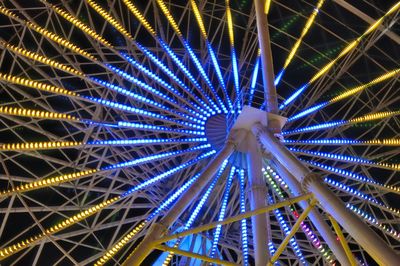 Low angle view of illuminated ferris wheel at night