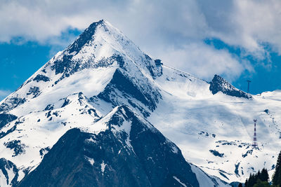 Low angle view of snowcapped mountains against sky