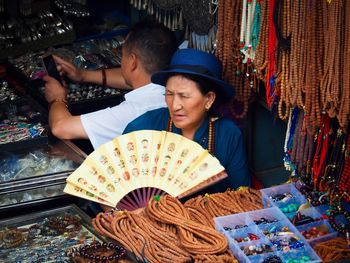 People enjoying at market stall